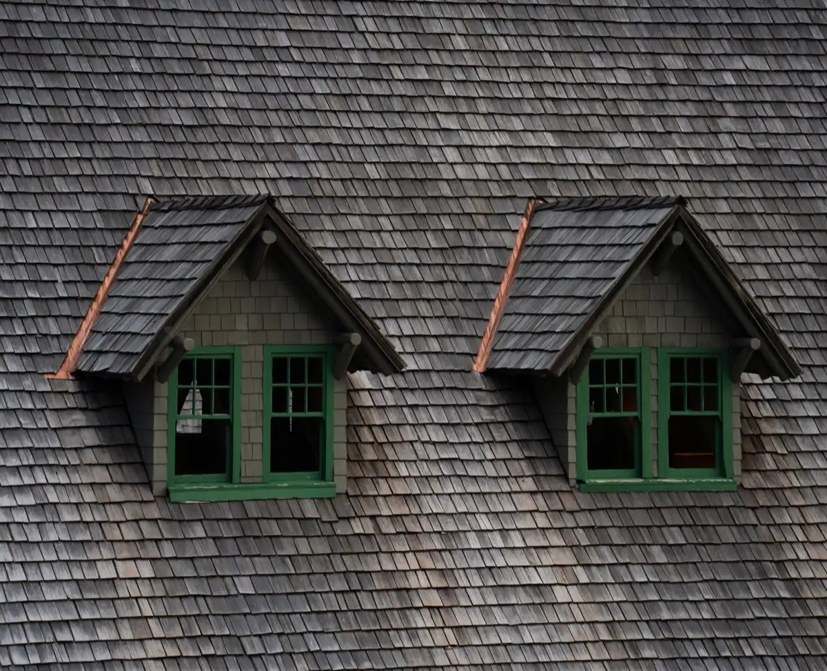 Dormers on a shingle roof in Greenville, SC, where step flashing and kickout flashing carry water past the walls